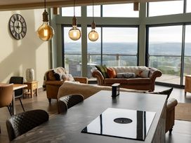A living room with a sofa and a kitchen island at Pendle View in Preston