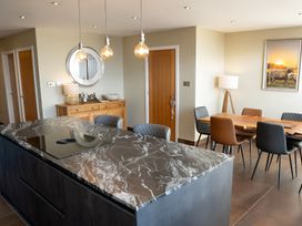 A kitchen with an island and dining area at Pendle View in Preston