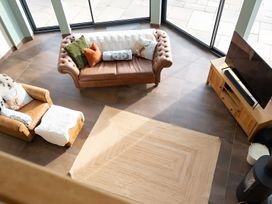 A living room with a sofa and armchair at Pendle View in Preston