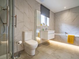 A bathroom with a shower, sink, toilet, and bathtub at Pendle View Preston
