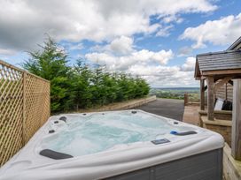 An outdoor area with a hot tub and fence at Pendle View in Preston