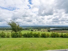 A view of green fields and a lake at Pendle View in Preston