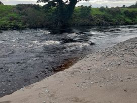 A river with sandy bank and gravel at The Farmhouse in Omagh