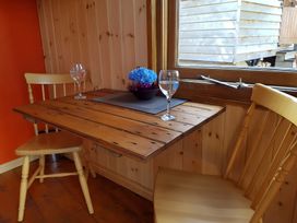 A dining area with a table and chairs at Bryn Mawr Cabin in Craven Arms