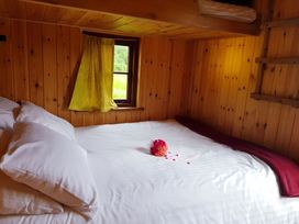 A bedroom with a bed and window at Bryn Mawr Cabin in Craven Arms