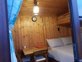 A bedroom with a bed and table at Bryn Mawr Cabin in Craven Arms