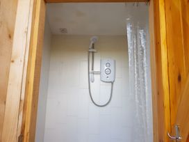 A shower with a control panel and curtain at Bryn Mawr Cabin in Craven Arms