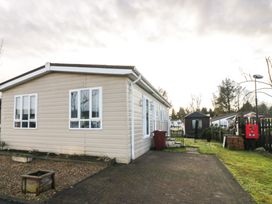An outdoor area with a house and a shed at Beechtree Lodge 46 Denny
