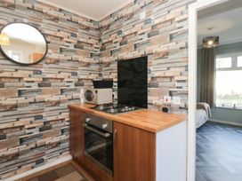 A kitchen with an oven and microwave at Beechtree Lodge 55 in Denny
