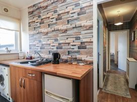 A kitchen with a sink and kettle at Beechtree Lodge 55 in Denny