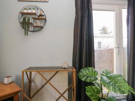 A living room with a table and a plant at Beechtree Lodge 56 in Denny