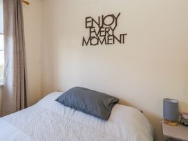 A bedroom with a bed and wall decor at Beechtree Lodge 56 Denny