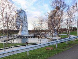 A sculpture of horses next to a water body at Beechtree Timber Lodge 69A Denny