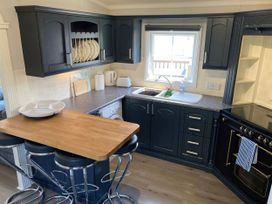 A kitchen with a sink and oven at Caravan 38 in Newport