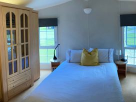 A bedroom with a bed and wardrobe at Caravan 38 in Newport