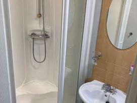 A bathroom with a shower and sink at Caravan 38 Newport