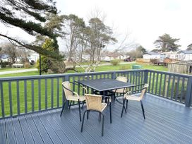 A deck with a table and chairs at Caravan 38 in Newport