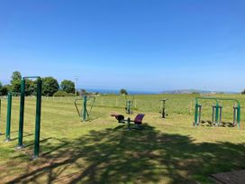 An outdoor fitness area with exercise equipment and a view of the ocean at Caravan 38 Newport
