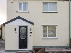 A house exterior with a black door and windows at Mables in Wigton