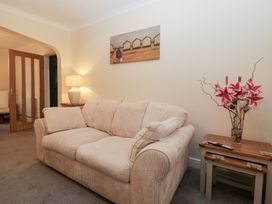 A living room with a sofa and lamp at Mables in Wigton