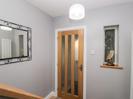 A hallway with a door and mirror at Mables in Wigton