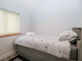 A bedroom with a bed and window at Mables in Wigton