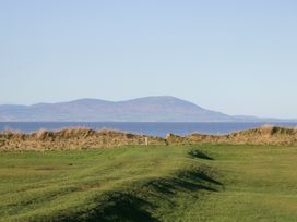 A landscape with grass, ocean, and mountains at Mables in Wigton