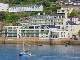 Buildings near water with boats in the bay at Villa 8, Estura Salcombe