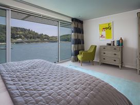 A bedroom with a bed, chair, and dresser at Villa 8, Estura in Salcombe