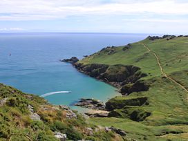 A scenic view of a coastline with hills and water at Villa 8, Estura Salcombe