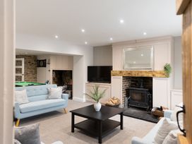 A living room with a coffee table and a television at 6 Front Street