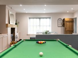 A pool table with billiard balls in a game room at 6 Front Street