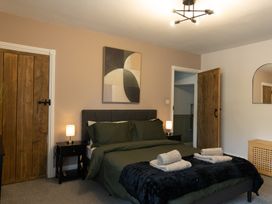 A bedroom with a bed and nightstands at 6 Front Street 