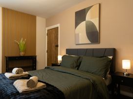 A bedroom with a bed and a plant at 6 Front Street