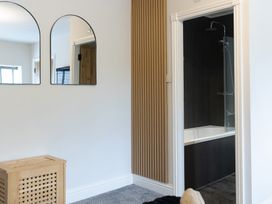 A bathroom with a shower and bathtub at 6 Front Street
