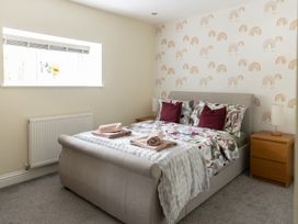 A bedroom with a bed and nightstand at 6 Front Street