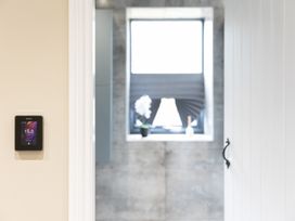 A thermostat and window view in a bathroom at 6 Front Street