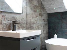 A bathroom with a sink and bathtub at 6 Front Street