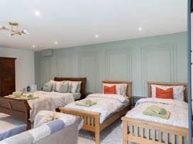A bedroom with multiple beds and furniture at 6 Front Street