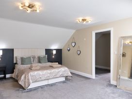 A bedroom with a bed and mirror at 6 Front Street 