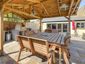 An outdoor dining area with a table and benches at The Old Sawmill in Burnopfield