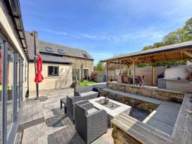 An outdoor area with seating, a fire pit, and a grill at The Old Sawmill in Burnopfield
