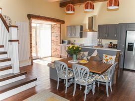A kitchen with a dining table and chairs at The Granary in Durham