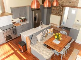 A kitchen with a dining area and modern appliances at The Granary in Durham