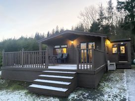 A cabin with a deck and steps at Cabin 1 Moffat Manor in Moffat