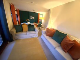 A living room with couches and dining area at Cabin 1 Moffat Manor in Moffat