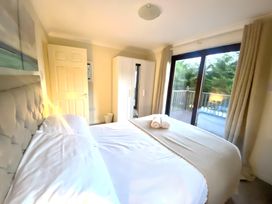A bedroom with a bed and wardrobe at Cabin 1 Moffat Manor in Moffat