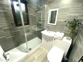 A bathroom with shower, sink, and toilet at Cabin 1 Moffat Manor in Moffat