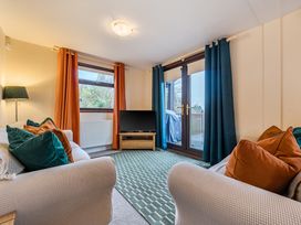 A living room with a television and sofa at Cabin 1 Moffat Manor Beaufort