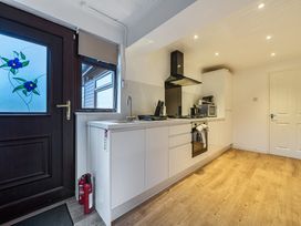 A kitchen with cabinets, stove, sink, and microwave at Cabin 1 Moffat Manor Beaufort